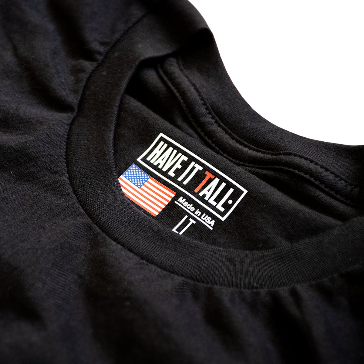 close up shot of Have It Tall made in USA T shirt in black 100% cotton luxury soft tee for tall men and women against a white background