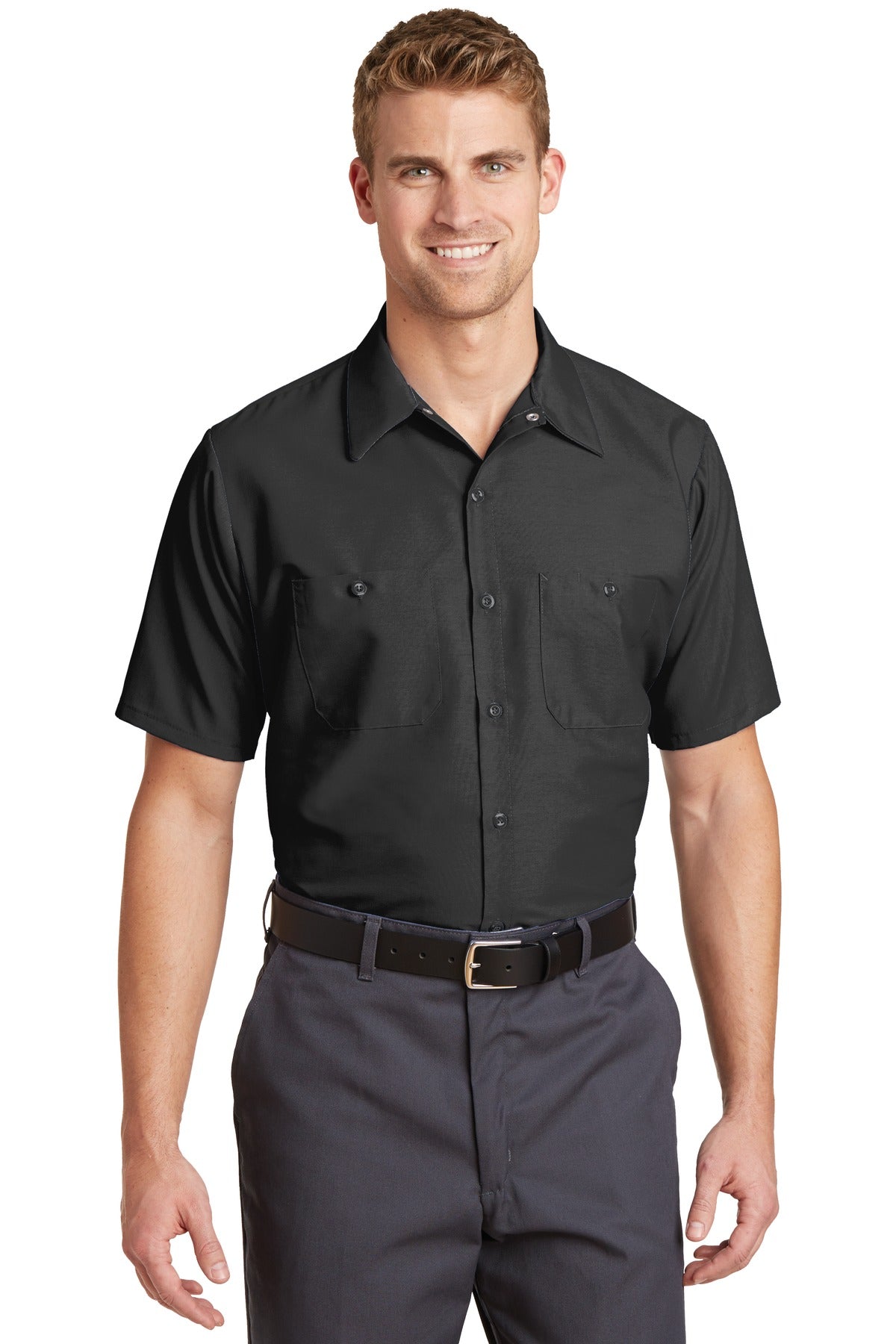 Tall male model 6'3 wearing a medium Red Kap Long Size Short Sleeve button up tee shirt Industrial Work Shirt in charcoal with dyed buttons against a white background