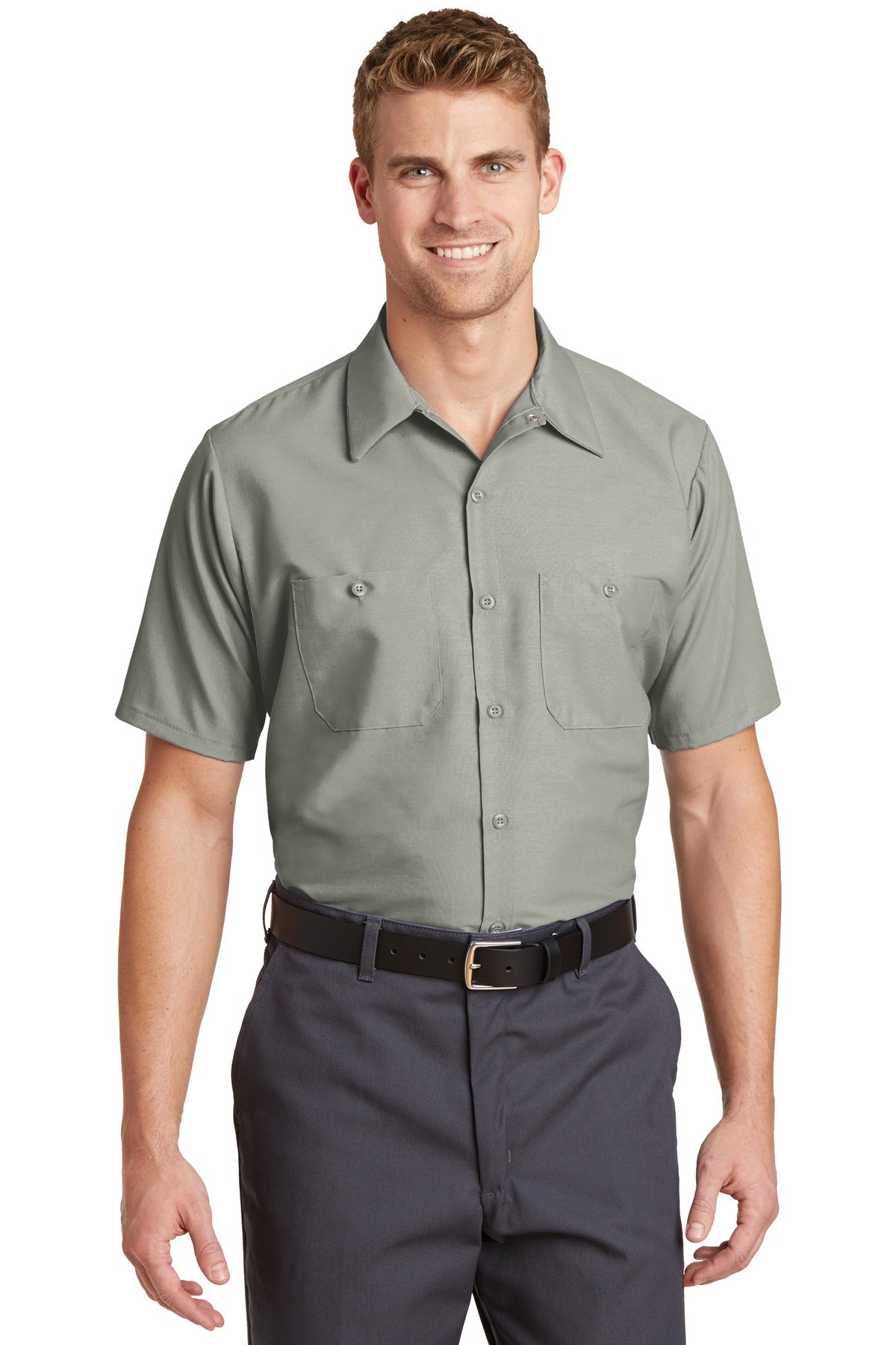 Tall male model 6'3 wearing a medium Red Kap Long Size Short Sleeve button up tee shirt Industrial Work Shirt in light grey with dyed buttons against a white background