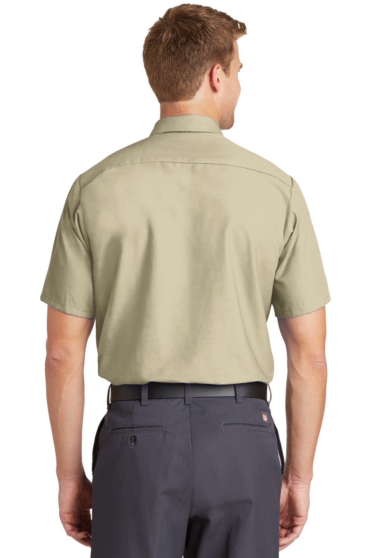 Tall male model 6'3 wearing a medium Red Kap Long Size Short Sleeve button up tee shirt Industrial Work Shirt in light tan with dyed buttons showing the back of the shirt against a white background