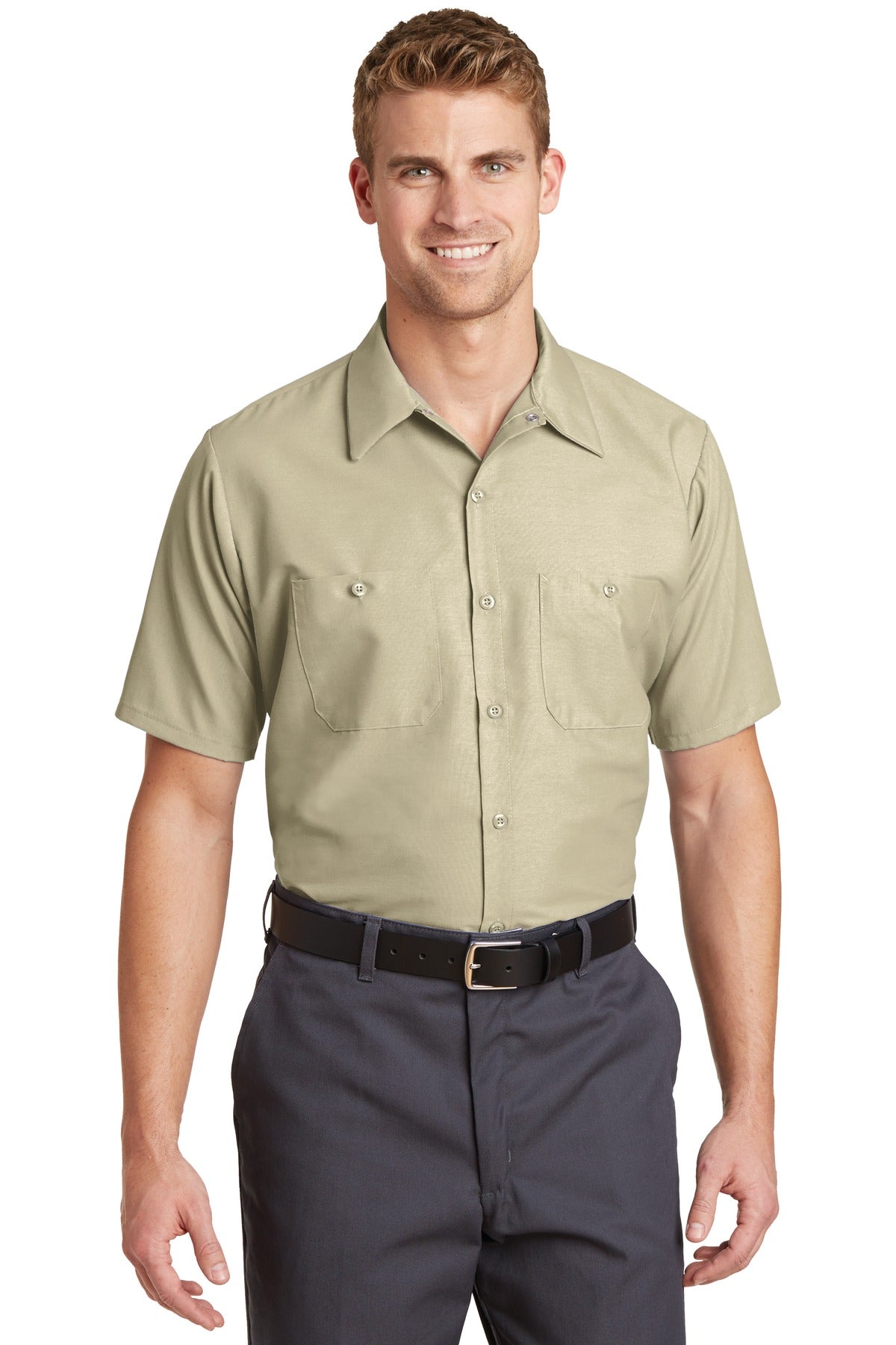 Tall male model 6'3 wearing a medium Red Kap Long Size Short Sleeve button up tee shirt Industrial Work Shirt in light tan with dyed buttons against a white background