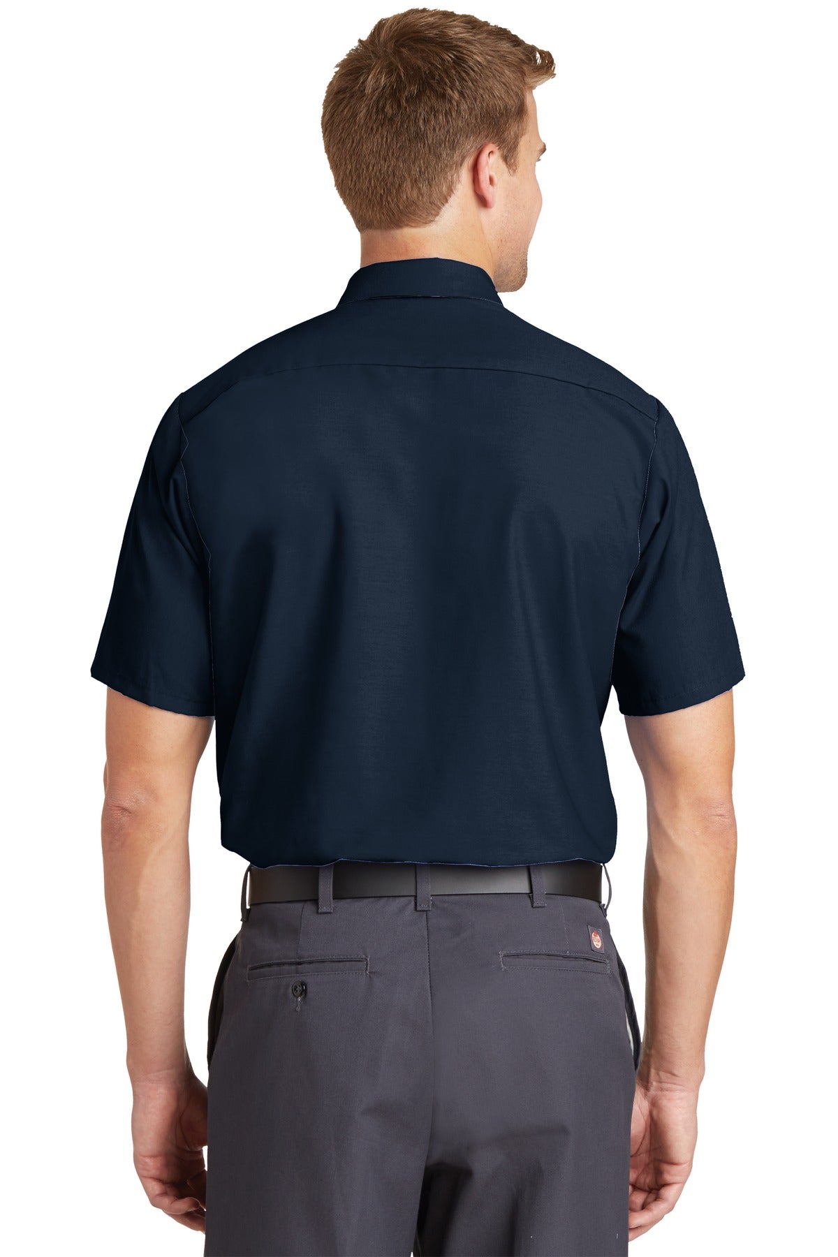 Tall male model 6'3 wearing a medium Red Kap Long Size Short Sleeve button up tee shirt Industrial Work Shirt in navy with dyed buttons showing the back of the shirt against a white background