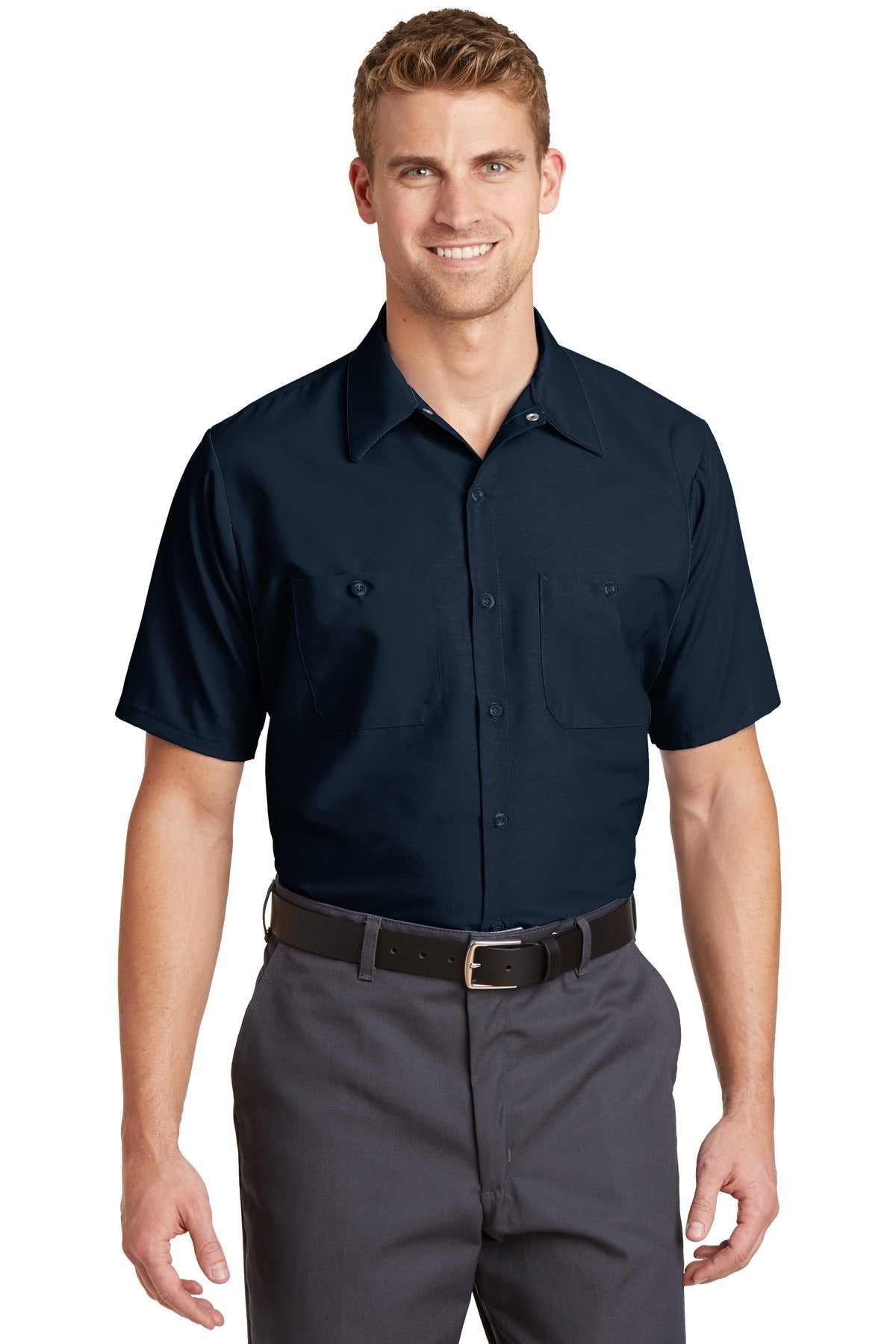 Tall male model 6'3 wearing a medium Red Kap Long Size Short Sleeve button up tee shirt Industrial Work Shirt in navy with dyed buttons against a white background