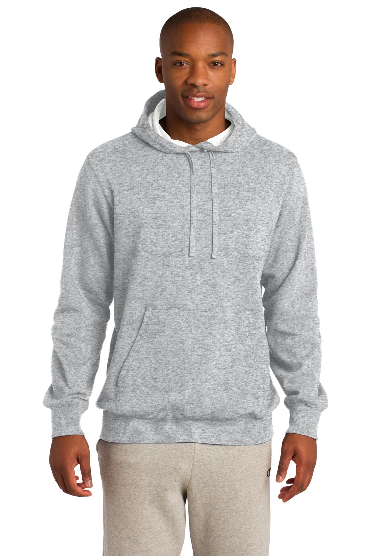 Tall male model 6'4 wearing a medium athletic heather colored hooded sweatshirt with large front pocket against a white background.