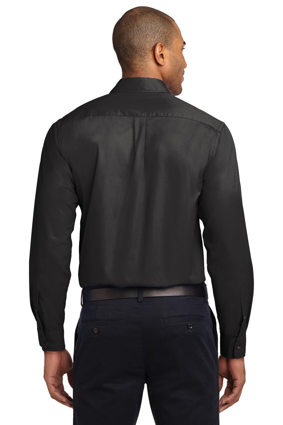 Tall male model 6,3 wearing a Medium long sleeve port authority button up shirt with chest pocket in color Black showing the back of the shirt against a white background