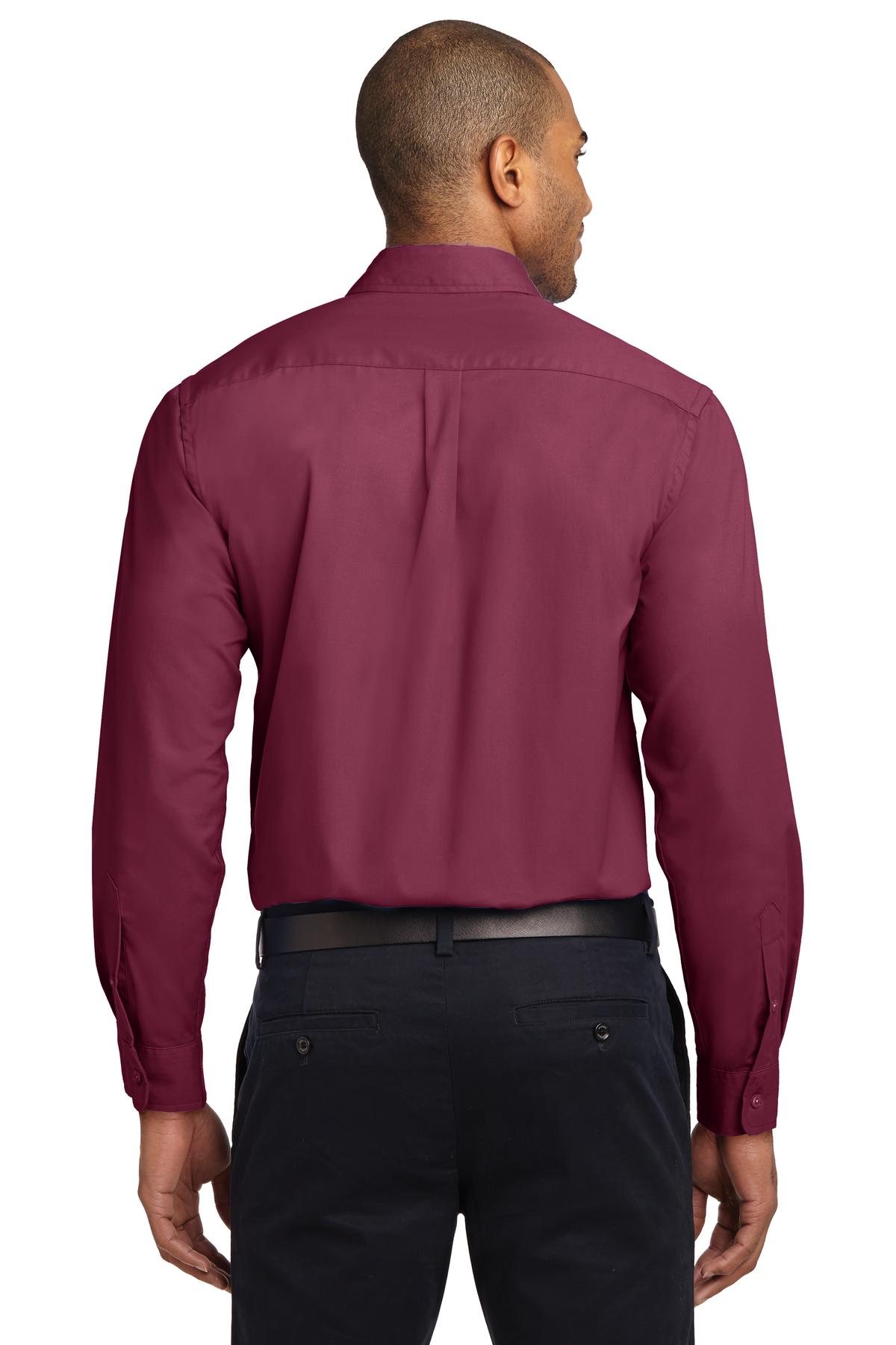 Tall male model 6,3 wearing a Medium long sleeve port authority button up shirt with chest pocket in color Burgundy showing the back of the shirt against a white background