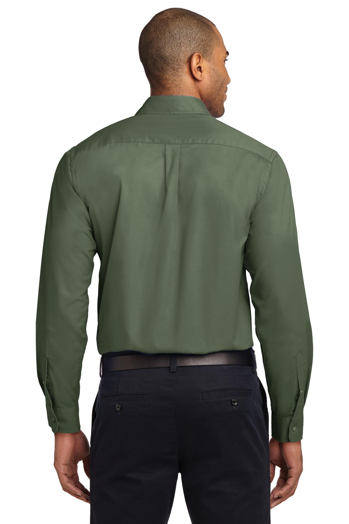 Tall male model 6,3 wearing a Medium long sleeve port authority button up shirt with chest pocket in color clover green showing the back of the shirt against a white background