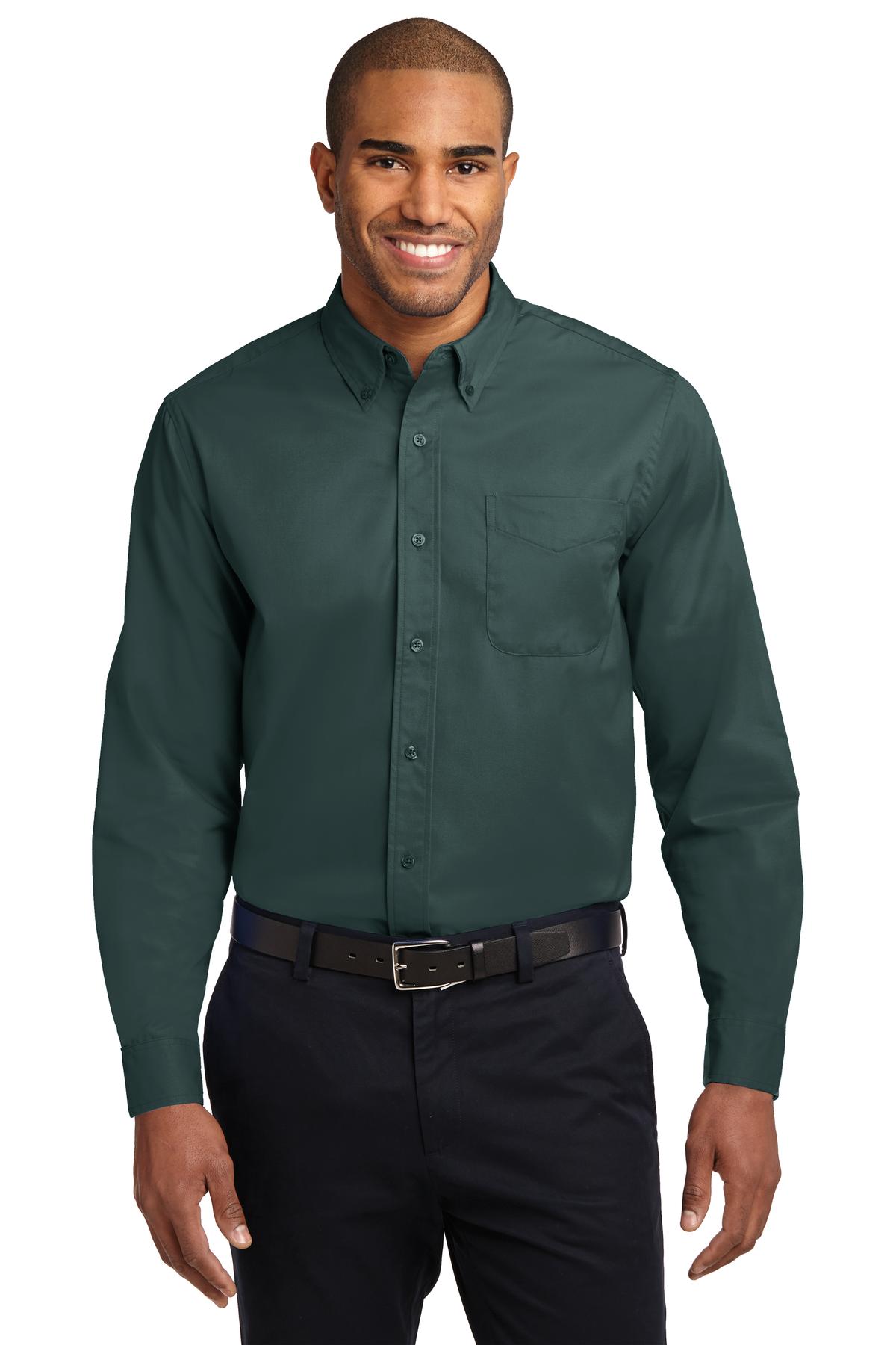 Tall male model 6,3 wearing a large long sleeve port authority button up shirt with chest pocket in color dark green against a white background