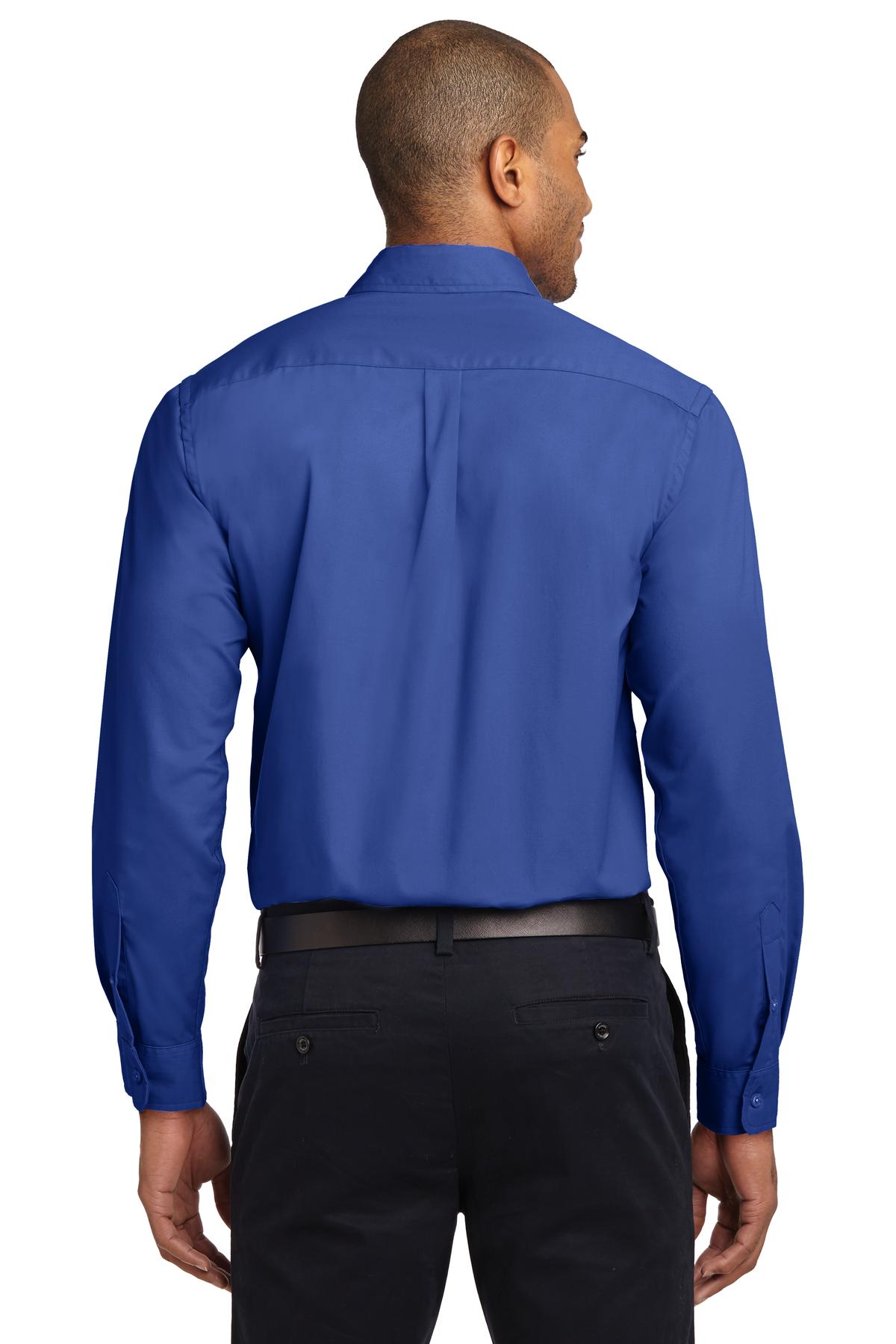 Tall male model 6,3 wearing a Medium long sleeve port authority button up shirt with chest pocket in color Royal showing the back of the shirt against a white background