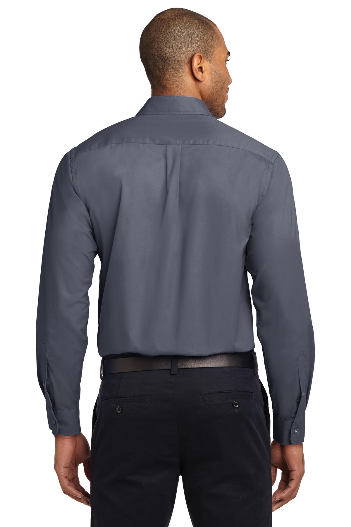 Tall male model 6,3 wearing a Medium long sleeve port authority button up shirt with chest pocket in color steel grey showing the back of the shirt against a white background