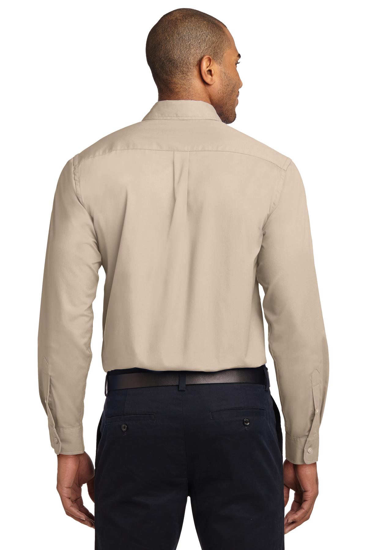 Tall male model 6,3 wearing a Medium long sleeve port authority button up shirt with chest pocket in color Tan showing the back of the shirt against a white background