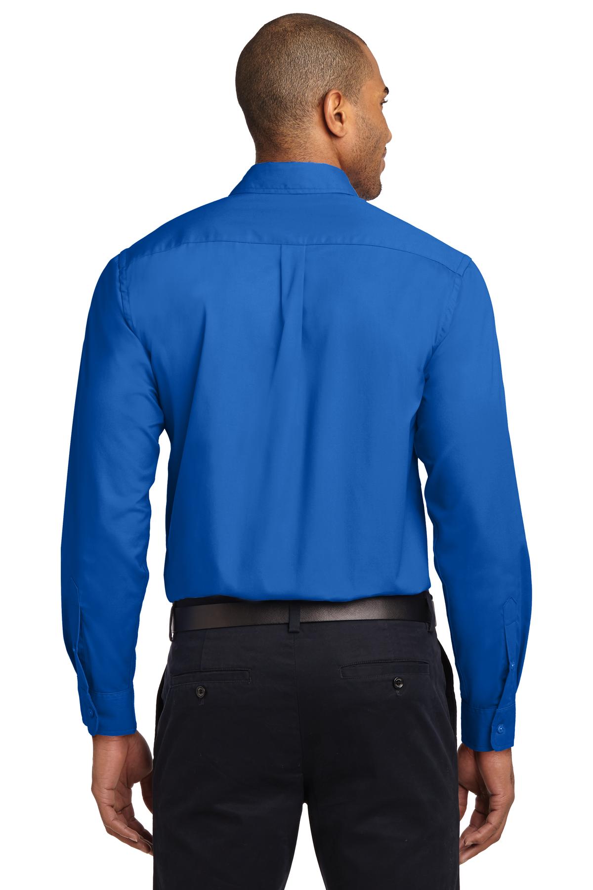 Tall male model 6,3 wearing a Medium long sleeve port authority button up shirt with chest pocket in color Strong blue showing the back of the shirt against a white background
