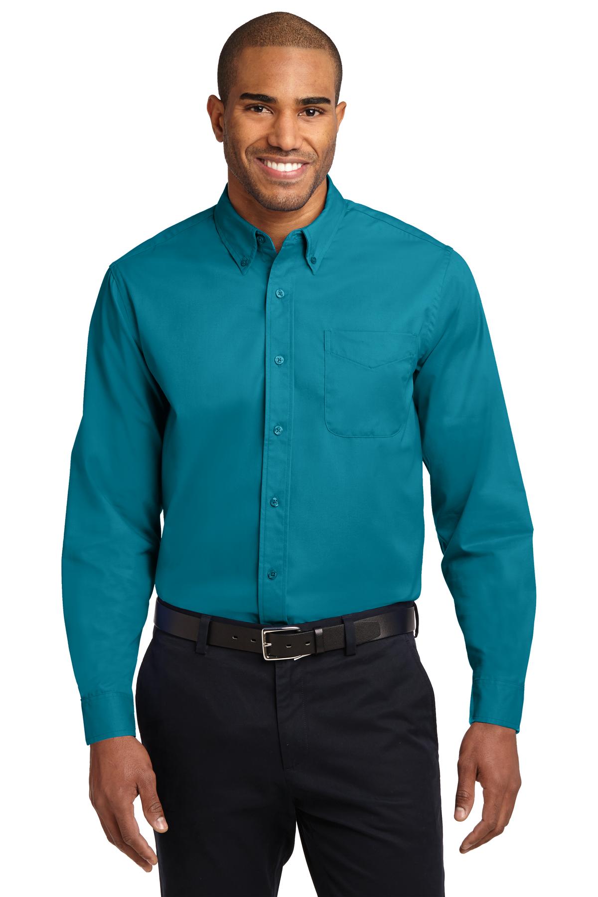 Tall male model 6,3 wearing a large long sleeve port authority button up shirt with chest pocket in color teal against a white background