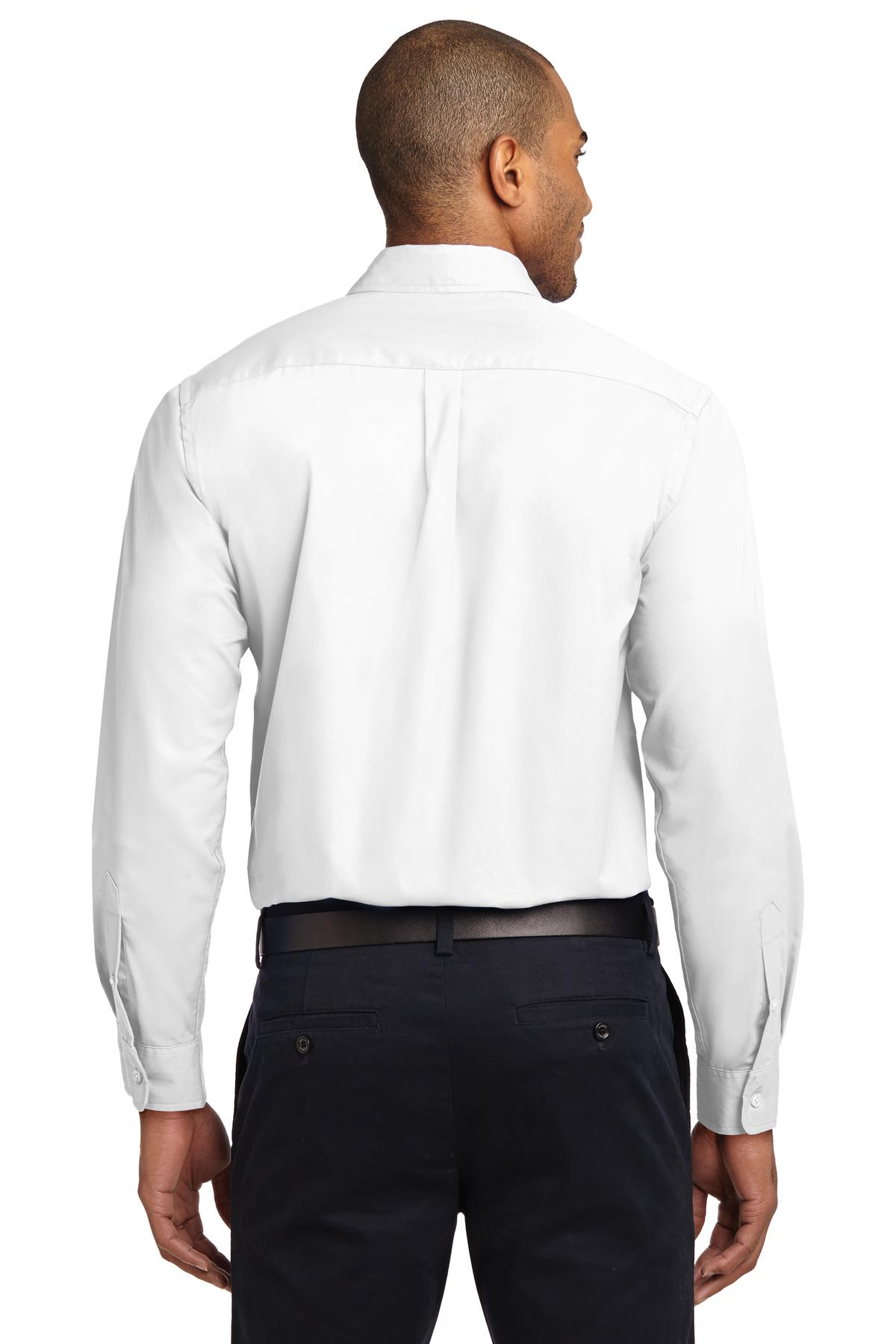 Tall male model 6,3 wearing a Medium long sleeve port authority button up shirt with chest pocket in color White showing the back of the shirt against a white background