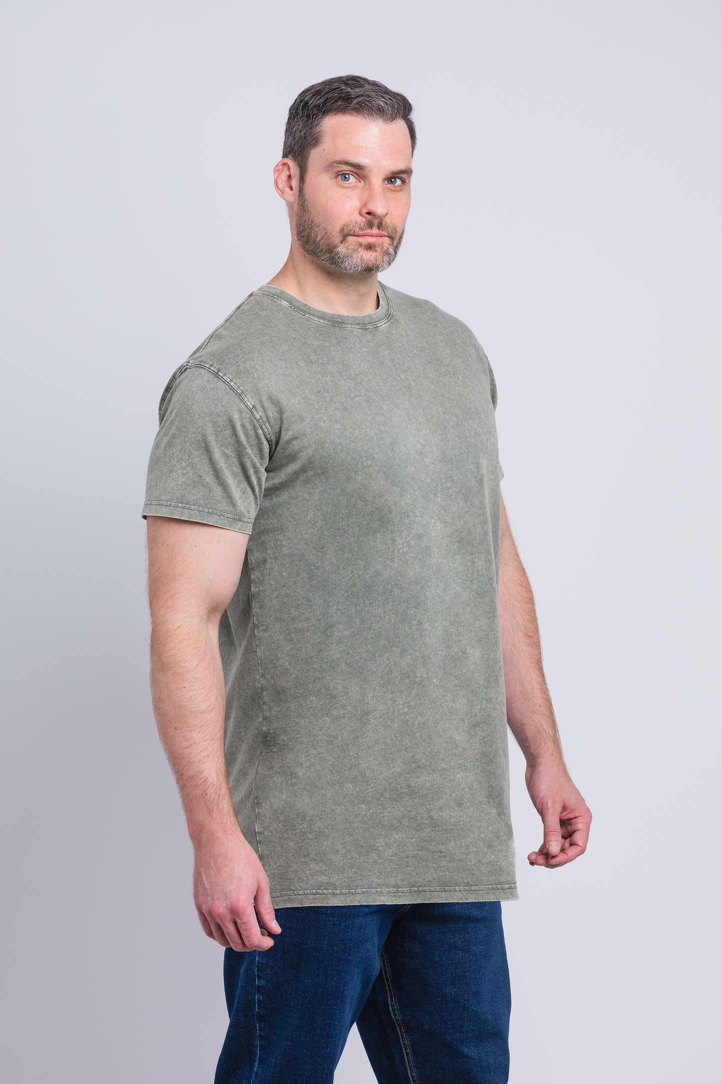 Tall male model 6,2 wearing a medium army Have It Tall vintage stone washed T shirt drier and washer safe tee against a white background
