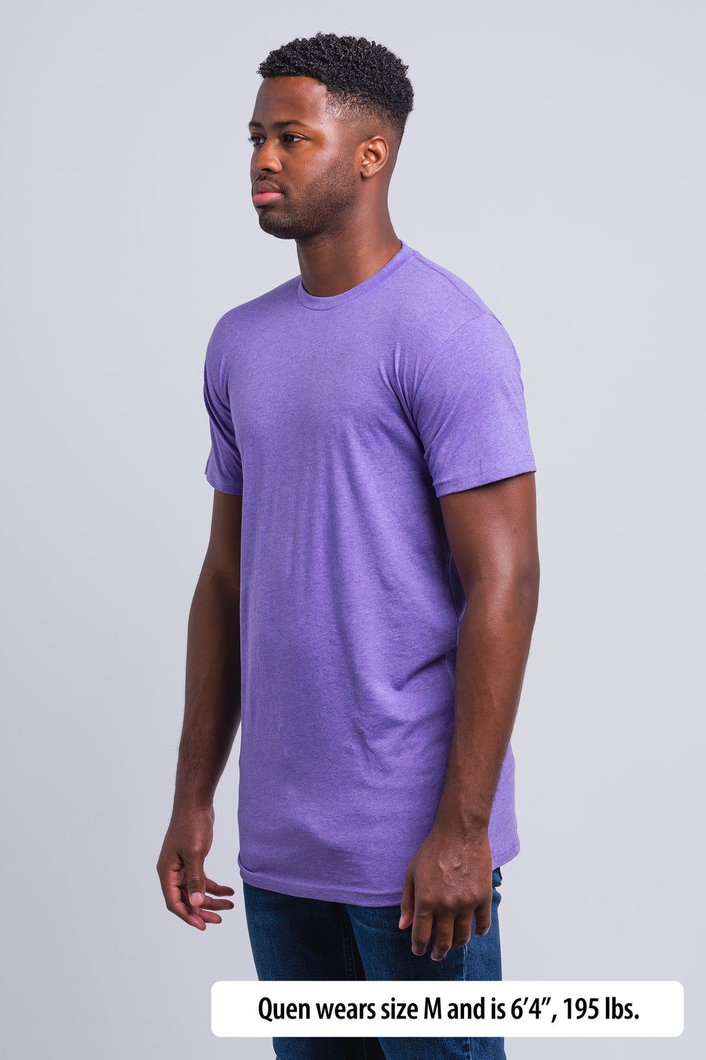 Have It Tall Extra Long Blend Tall T Shirt worn by a male model (6'4" tall) wearing a size Medium Heather Lilac standing in a tall apparel showroom.