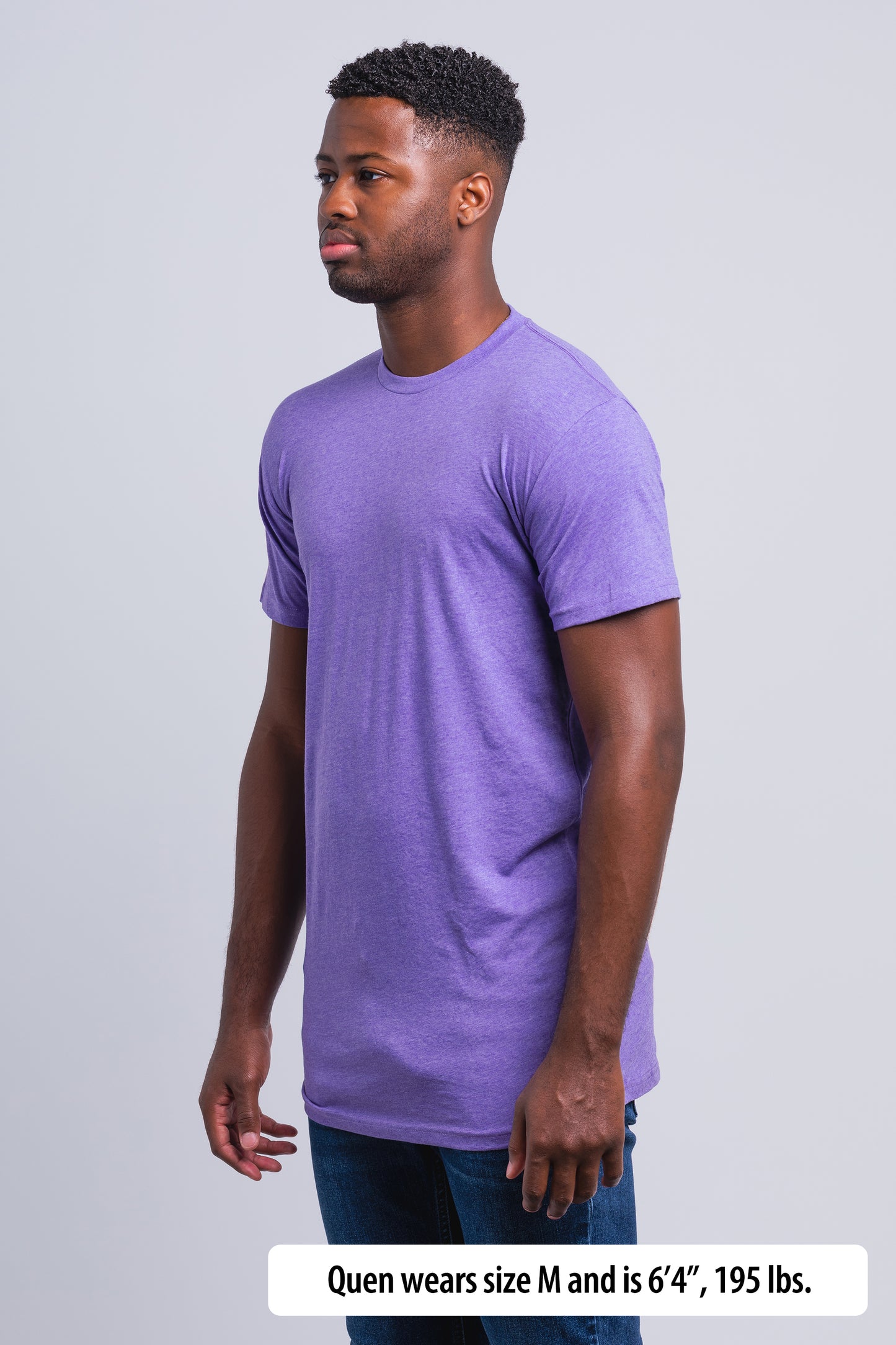 Have It Tall Extra Long Blend Tall T Shirt worn by a male model (6'4" tall) wearing a size Medium Heather Lilac standing in a tall apparel showroom.