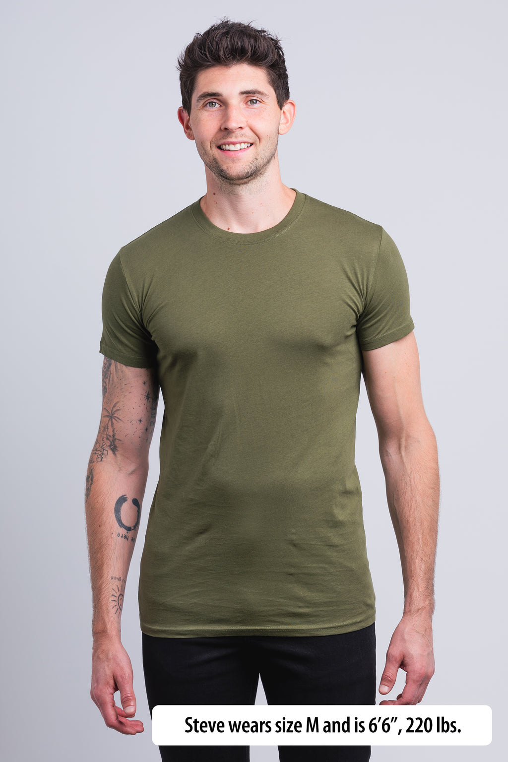 Have It Tall Classic Tall T Shirt worn by a male model (6'6" tall) wearing a size Medium Olive Drab standing in a tall apparel showroom.