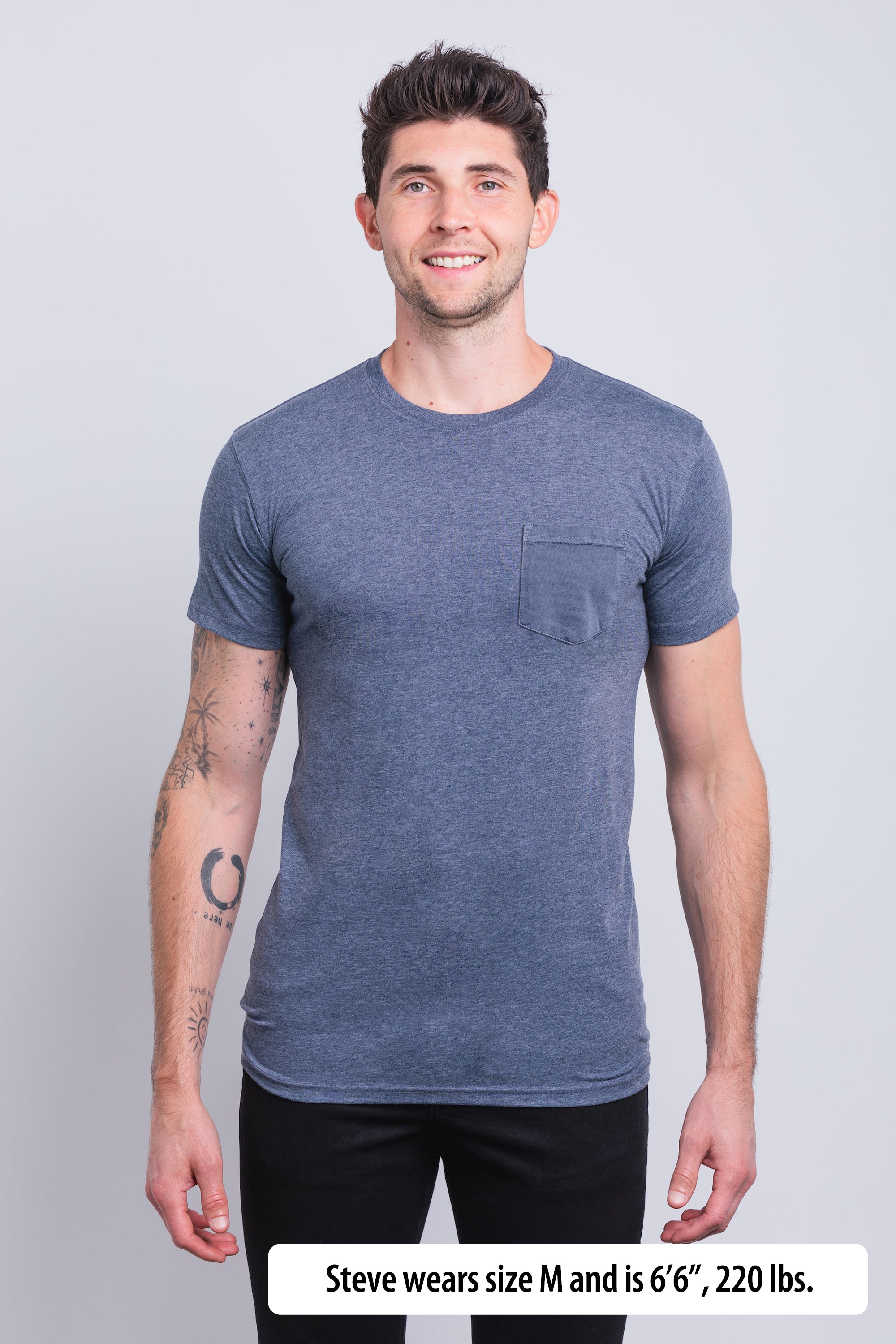 Have It Tall Fashion Fit Tall pocket T Shirt worn by a male model (6'6" tall) wearing a medium large Heather navy standing against a black background.