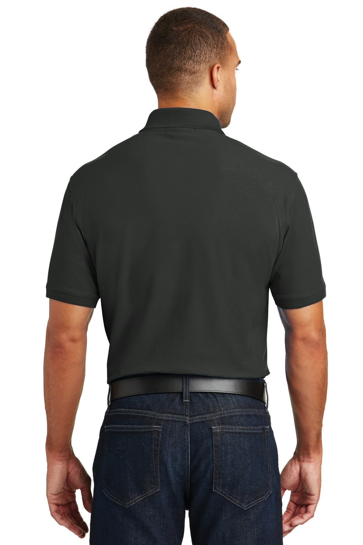 Tall male model 6'4 wearing a medium deep black Port Authority Tall Core Classic Pique Polo built for durability showing the back of the shirt against a white background