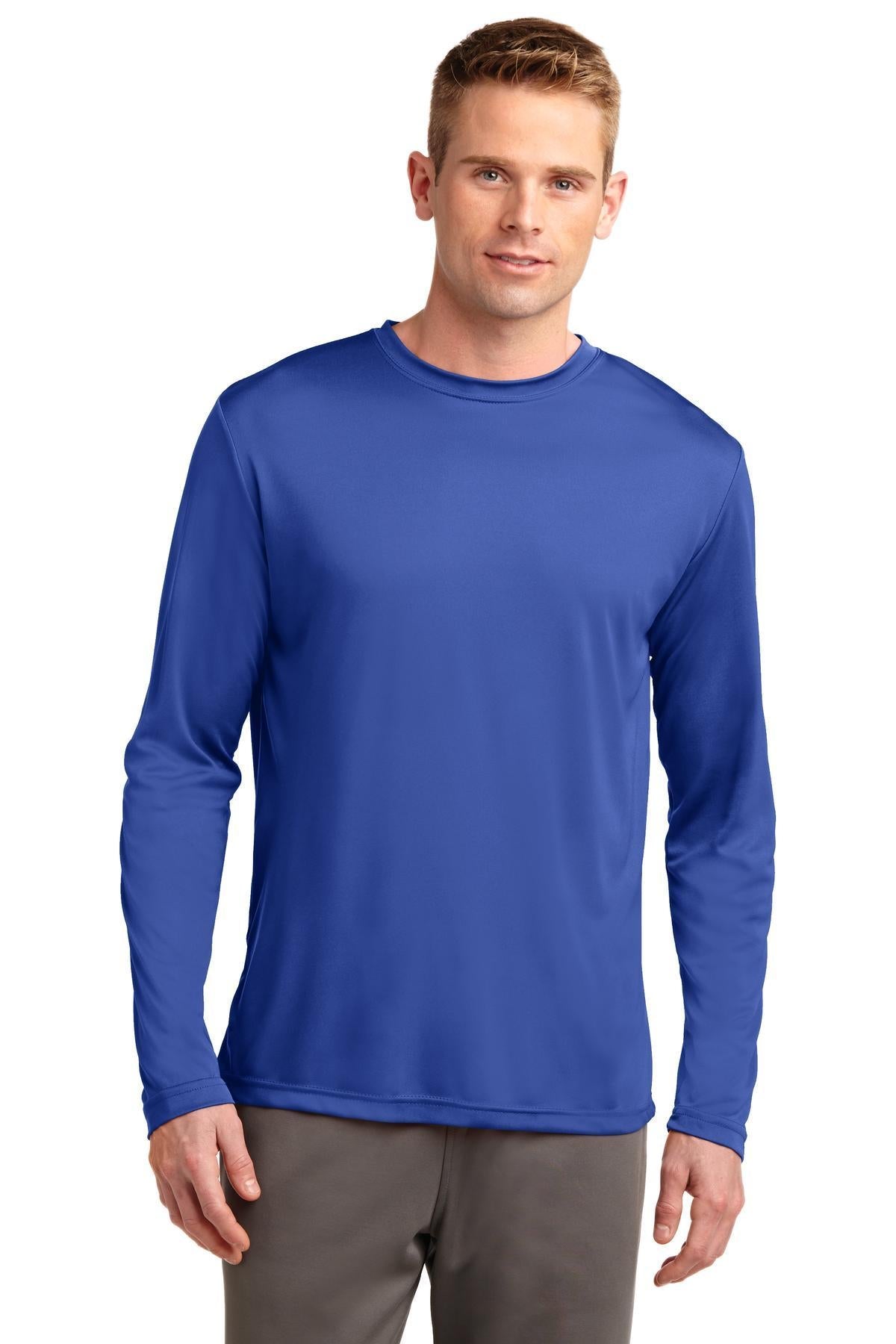 Tall male model 6,4 wearing a true navy sport tek long sleeve T shirt 100% poly Tee with removable tag for comfort against a white background